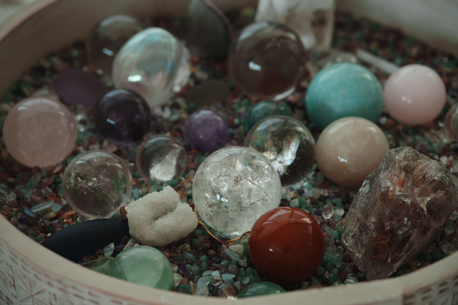 child using a National Geographic rock tumbler with polished stones on a table