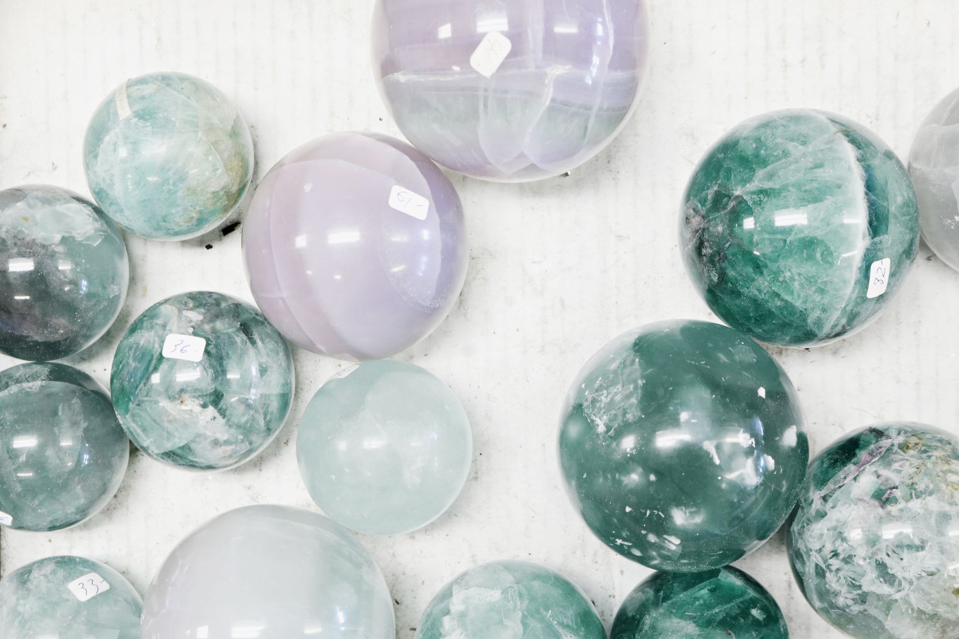 polished banded agate stones arranged on a white background