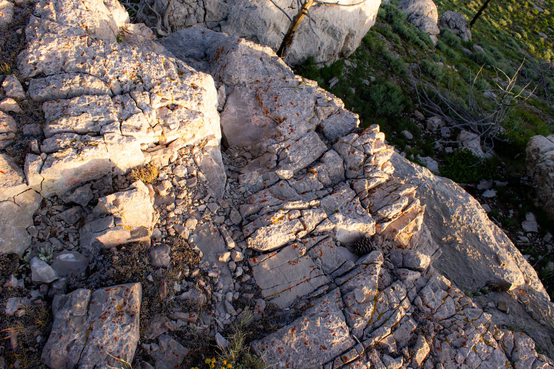 Exploring sunlit rocky terrain at golden hour in Wyoming's wilderness, featuring unique geological formations.