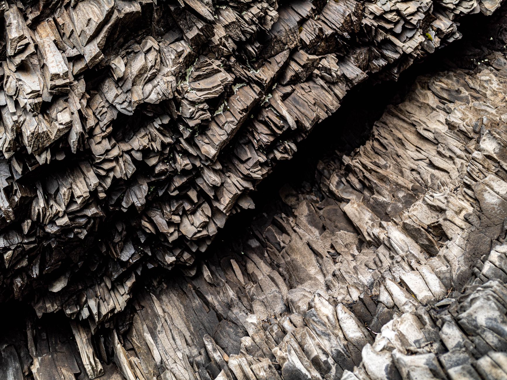 Detailed view of unique basalt rock formations in Vik, Iceland, showcasing natural texture and pattern.
