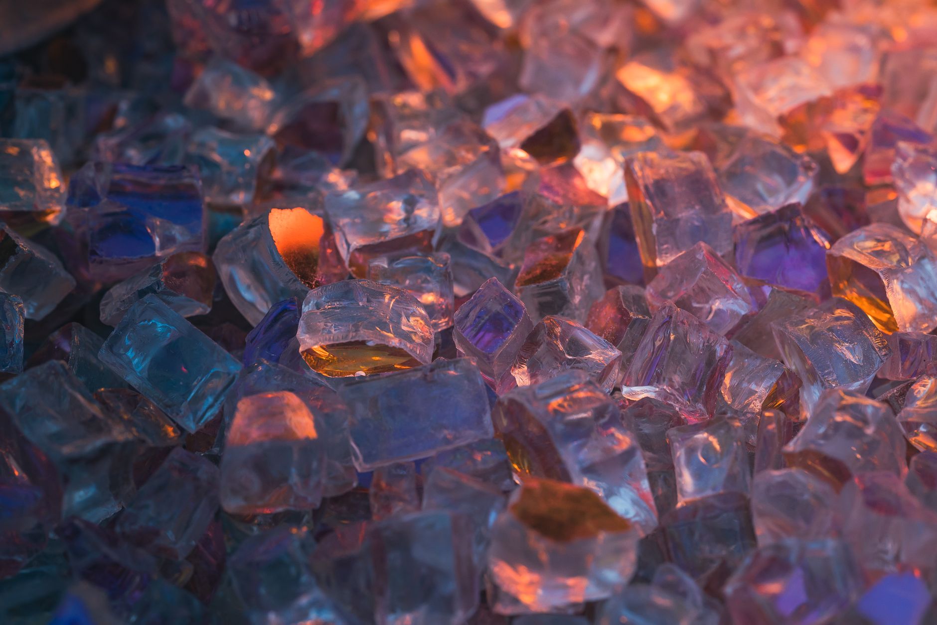 pieces of broken blue green and clear glass inside a small rubber tumbler barrel